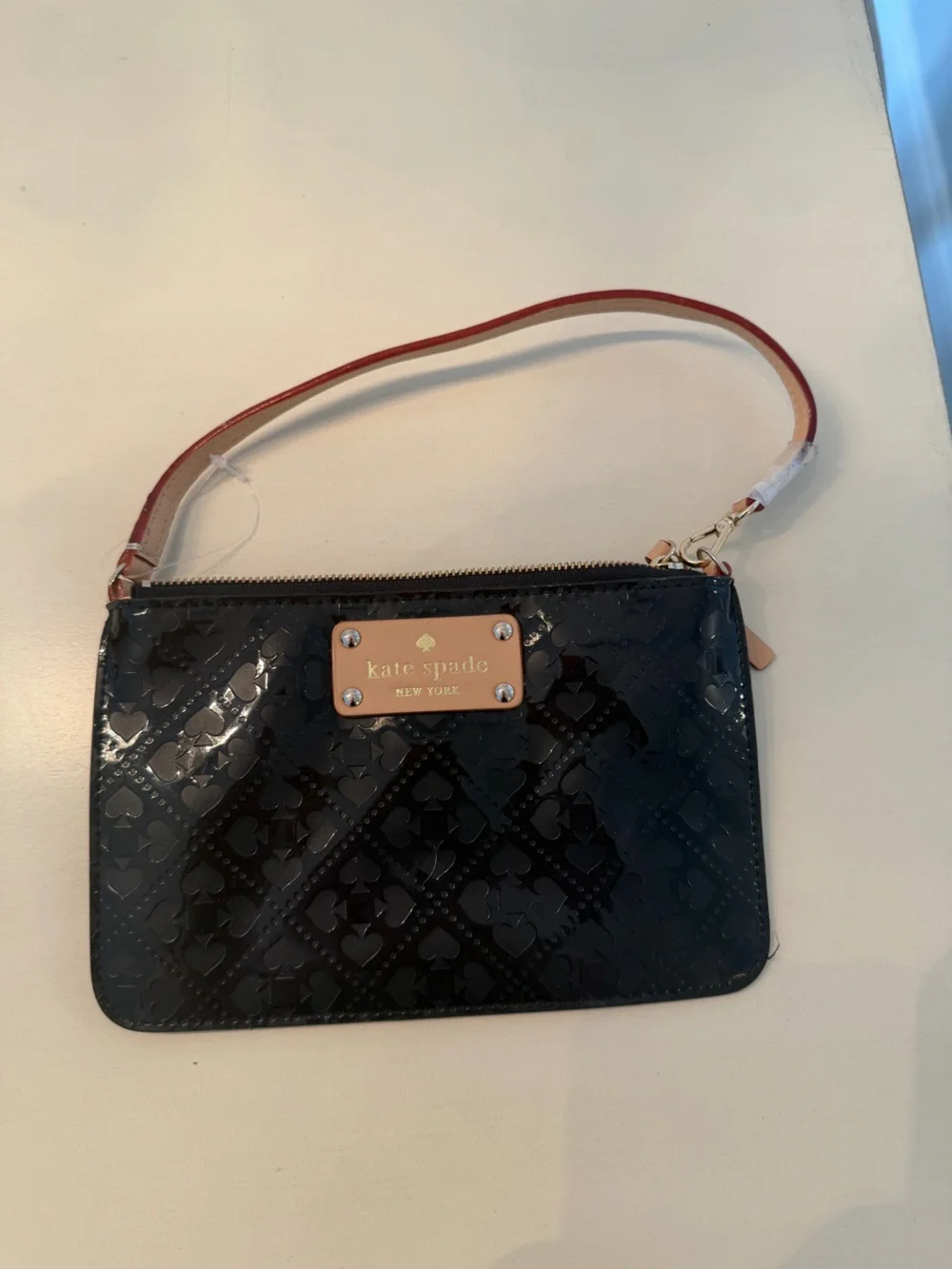kate spade Black Patent Wristlet with Tan Logo Plaque and Red-Trim Strap